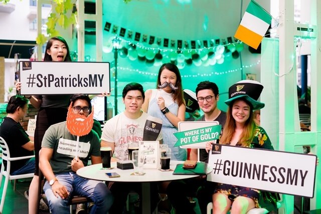 Guests at the GUINNESS St Patrick's Event at SOULed OUT posing with photo props